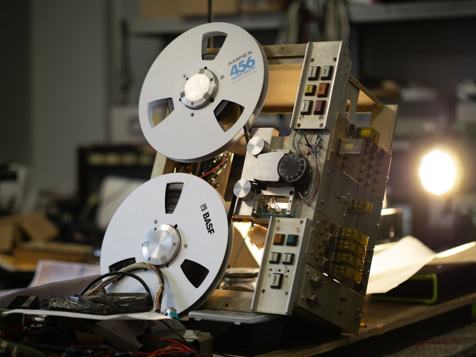Detailed shot of a rotating audio tape on a professional reel-to-reel machine.