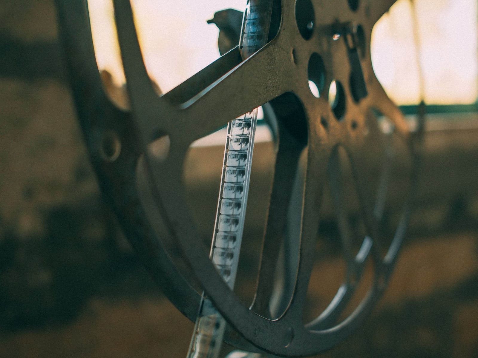 A Super 8 film reel resting on a wooden table in a bright studio.